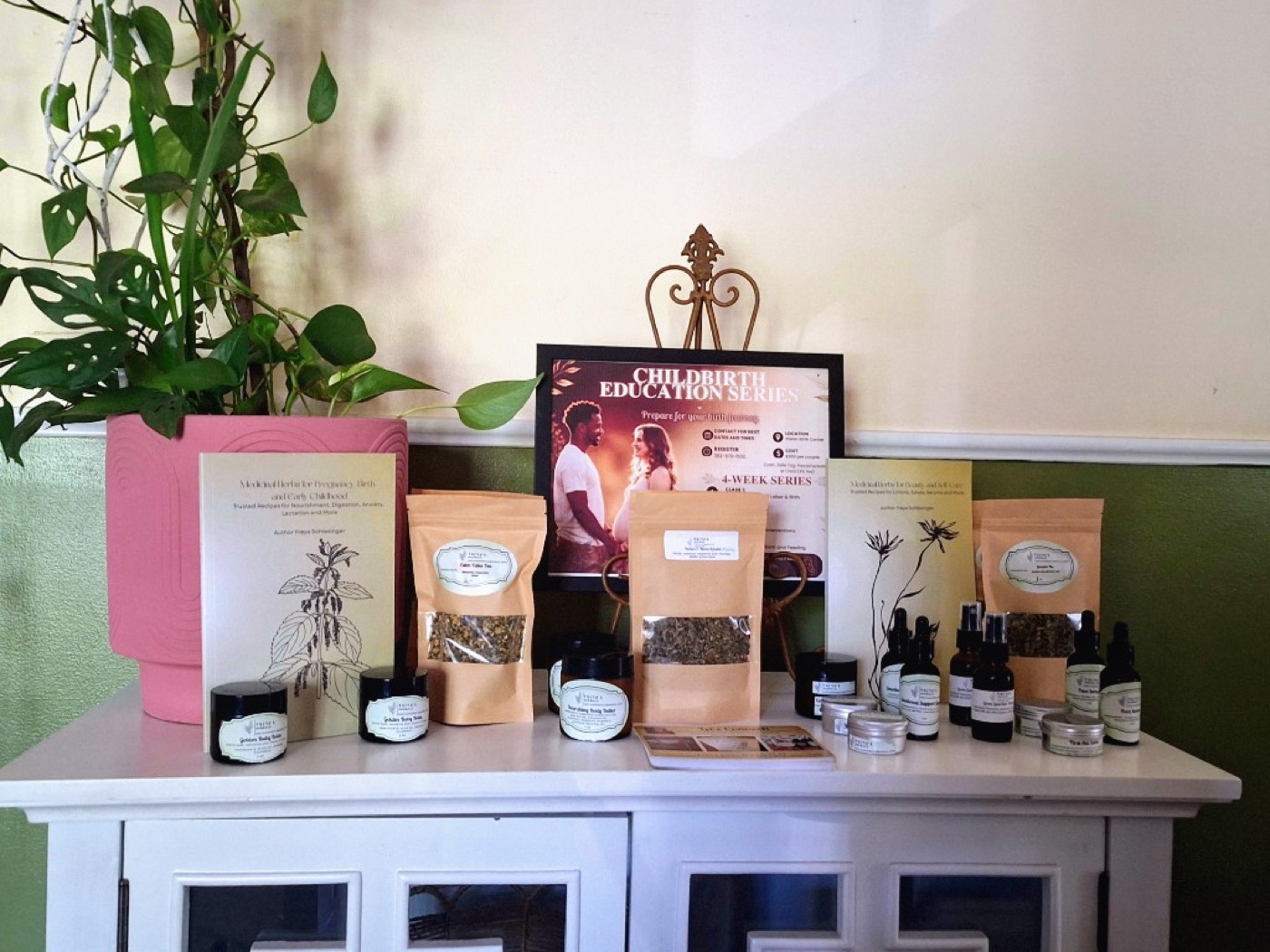 Freya's Herbals product display at a birth center with teas, balms, books, and herbal remedies